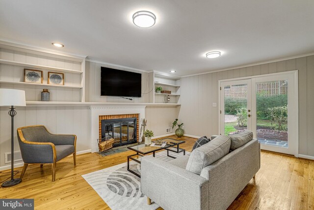 6515 Walters Woods Dr, Falls Church, VA 22044 - living room with wood finished floors, visible vents, a fireplace, and ornamental molding