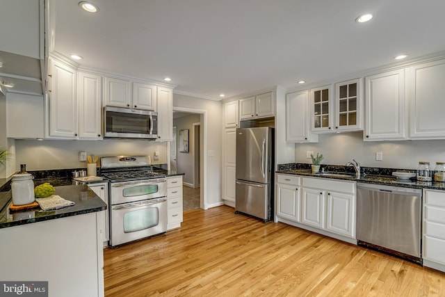 6515 Walters Woods Dr, Falls Church, VA 22044 - kitchen with white cabinets, recessed lighting, a sink, light wood-style flooring, and appliances with stainless steel finishes