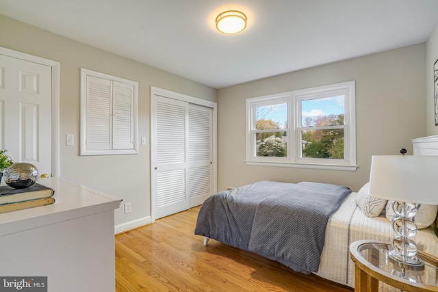 6515 Walters Woods Dr, Falls Church, VA 22044 - bedroom featuring baseboards, light wood finished floors, and a closet