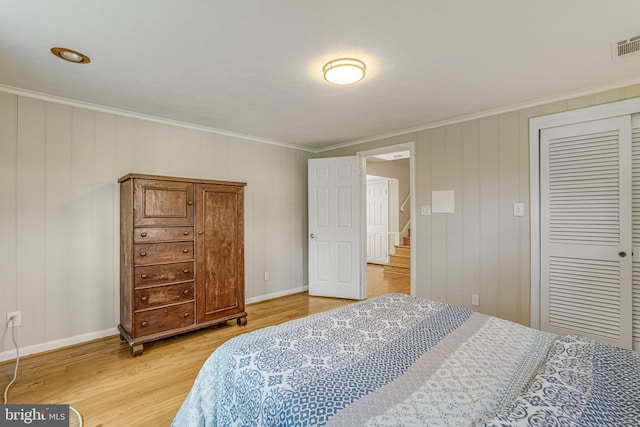 6515 Walters Woods Dr, Falls Church, VA 22044 - bedroom with baseboards, a closet, light wood-style floors, and ornamental molding