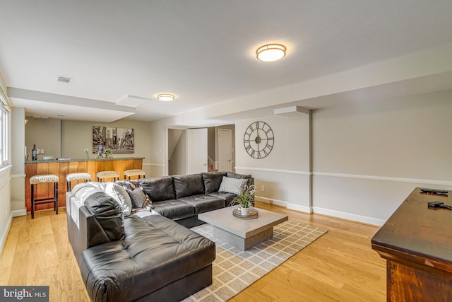 6515 Walters Woods Dr, Falls Church, VA 22044 - living area with baseboards, visible vents, indoor bar, and light wood-style flooring