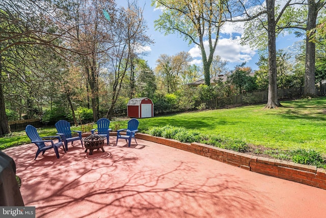 6515 Walters Woods Dr, Falls Church, VA 22044 - view of patio / terrace featuring a storage unit, an outbuilding, a fenced backyard, and an outdoor fire pit