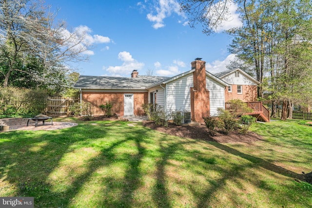 6515 Walters Woods Dr, Falls Church, VA 22044 - rear view of house featuring a yard, central AC unit, a chimney, and fence