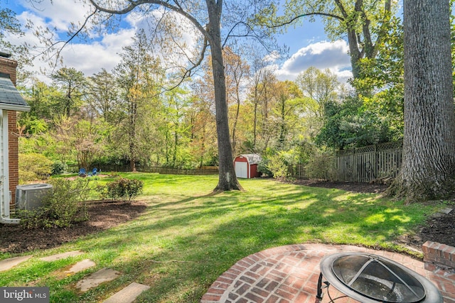 6515 Walters Woods Dr, Falls Church, VA 22044 - view of yard with a fenced backyard, an outdoor fire pit, a storage unit, and central air condition unit