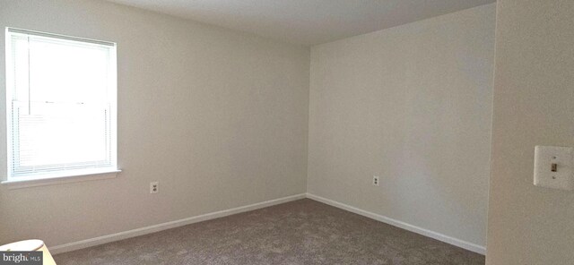 carpeted empty room with baseboards and plenty of natural light