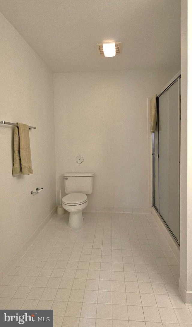 bathroom with visible vents, tile patterned floors, toilet, and a shower stall