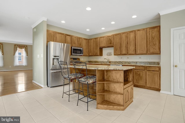 kitchen with a center island, open shelves, recessed lighting, light stone countertops, and stainless steel appliances