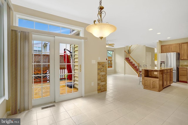 interior space featuring recessed lighting, visible vents, light tile patterned flooring, baseboards, and stairs