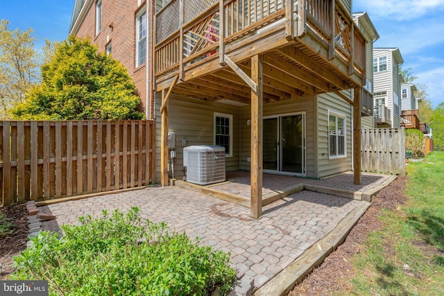 back of property with central AC, fence, a deck, and a patio