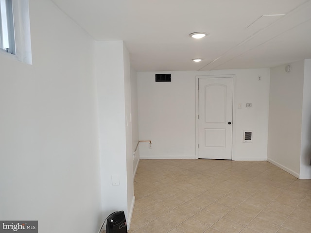 empty room featuring baseboards and visible vents