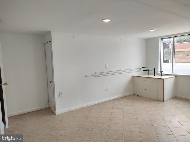 spare room featuring baseboards, recessed lighting, and light tile patterned flooring