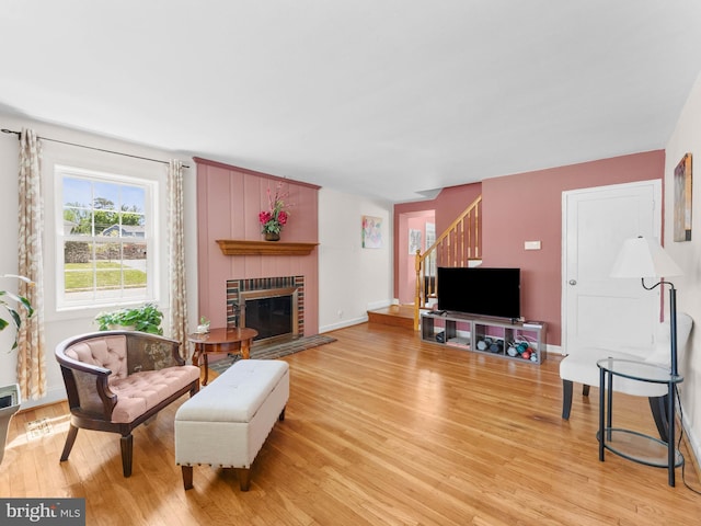 600 Maplewood Rd, Springfield, PA 19064 - living room featuring stairway, baseboards, a fireplace, and light wood-style flooring