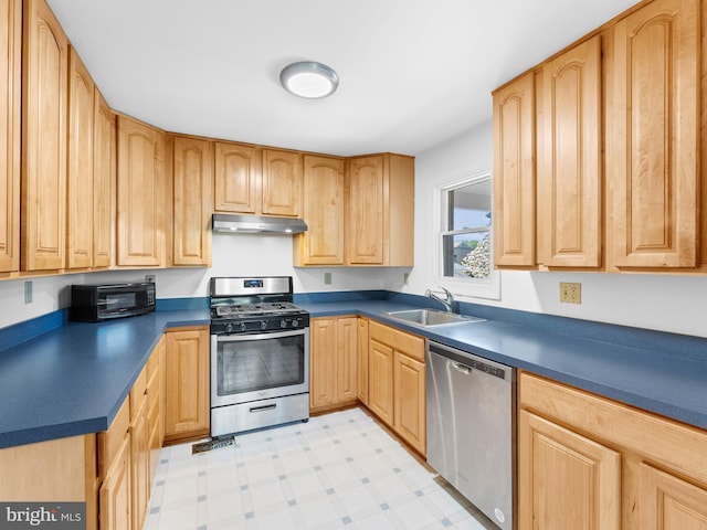 600 Maplewood Rd, Springfield, PA 19064 - kitchen with dark countertops, a sink, light brown cabinets, stainless steel appliances, and light floors