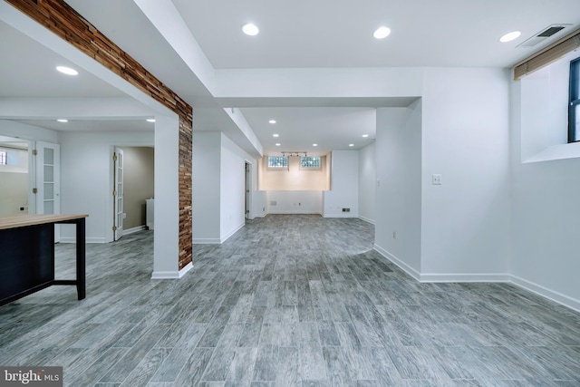 unfurnished living room featuring visible vents, recessed lighting, baseboards, and wood finished floors