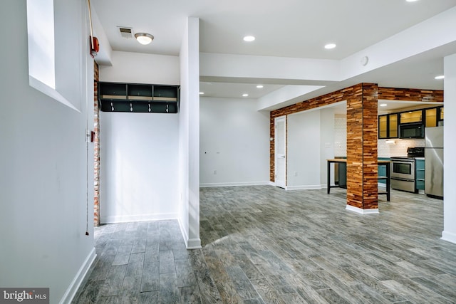unfurnished living room featuring baseboards, recessed lighting, wood finished floors, and visible vents