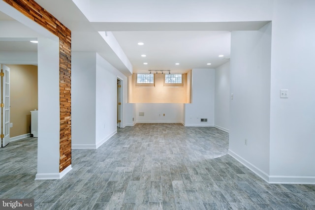 interior space featuring recessed lighting, baseboards, and wood finished floors