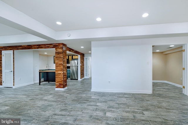 unfurnished living room with baseboards and recessed lighting