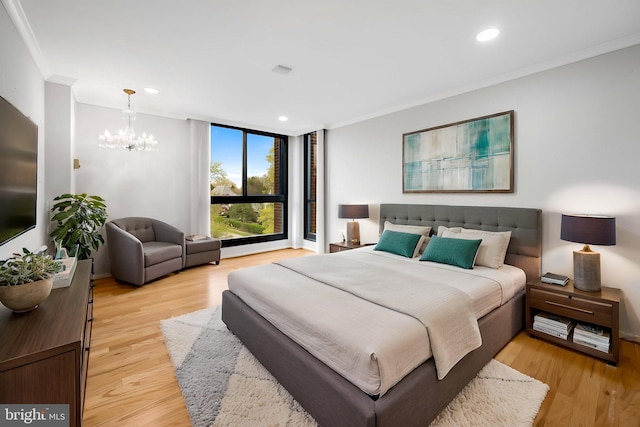 bedroom with an inviting chandelier, light wood-style floors, recessed lighting, and ornamental molding