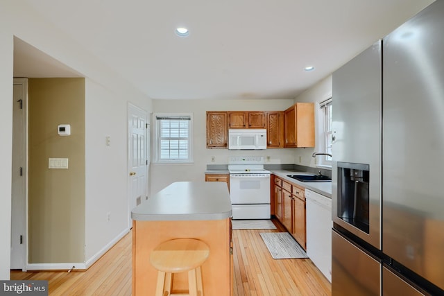 365 Hickory Trl, Crownsville, MD 21032 - kitchen featuring a sink, light wood-type flooring, white appliances, and a kitchen island