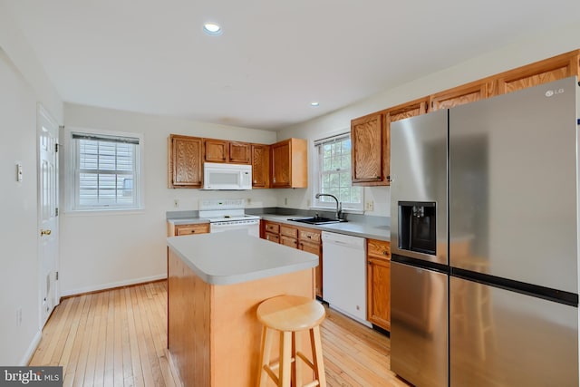365 Hickory Trl, Crownsville, MD 21032 - kitchen featuring a sink, light countertops, white appliances, light wood-style floors, and a kitchen island
