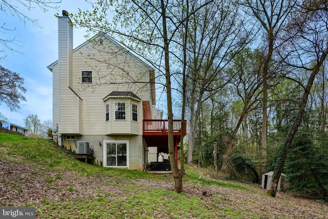 365 Hickory Trl, Crownsville, MD 21032 - back of property featuring a wooden deck, cooling unit, and a chimney