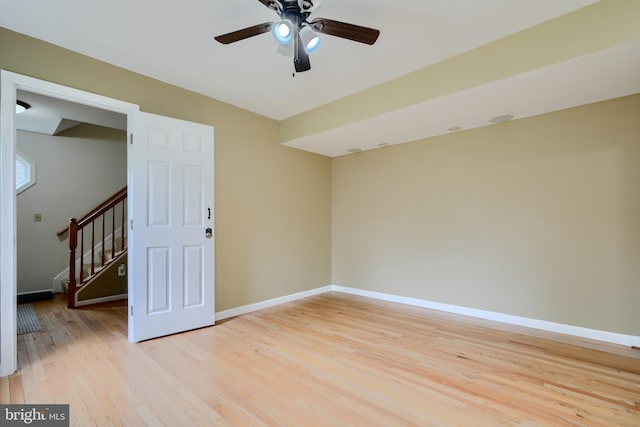 365 Hickory Trl, Crownsville, MD 21032 - spare room with baseboards, light wood-type flooring, ceiling fan, and stairway
