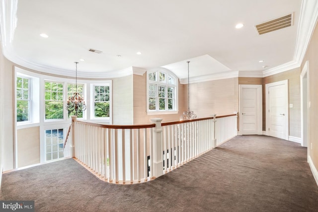 corridor featuring carpet floors, crown molding, and visible vents