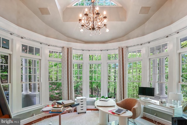 sunroom with a notable chandelier and lofted ceiling