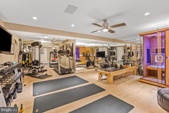 workout area with a ceiling fan, recessed lighting, and wood finished floors