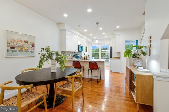dining area featuring light wood-style floors and recessed lighting