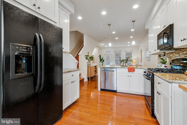kitchen featuring black appliances, a peninsula, light wood-style floors, white cabinetry, and recessed lighting