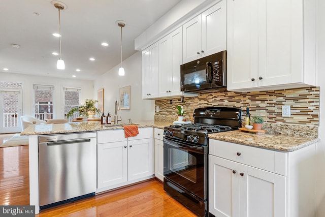 kitchen featuring black appliances, a peninsula, light wood-type flooring, white cabinets, and recessed lighting