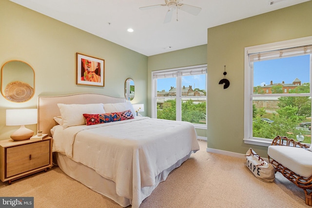 bedroom featuring light carpet, multiple windows, baseboards, recessed lighting, and ceiling fan