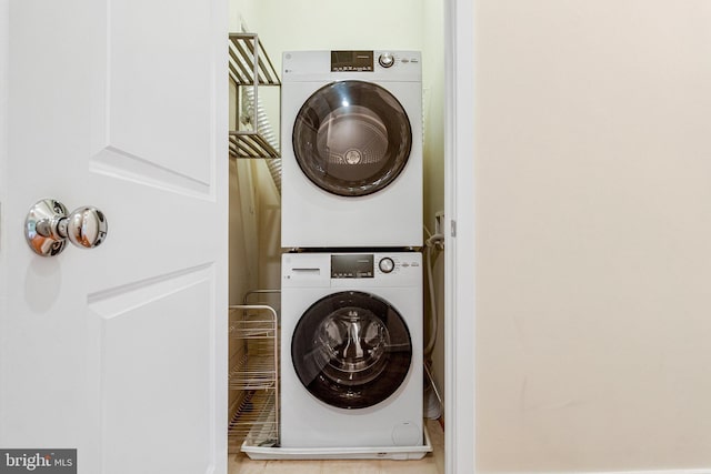laundry room with stacked washer / drying machine