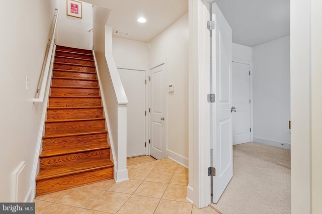 stairs featuring tile patterned flooring, recessed lighting, and baseboards