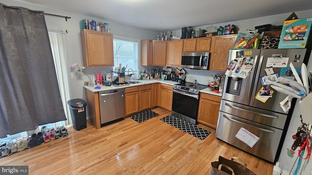 101 Commerce St, Hurlock, MD 21643 - kitchen featuring light countertops, a sink, appliances with stainless steel finishes, and light wood finished floors