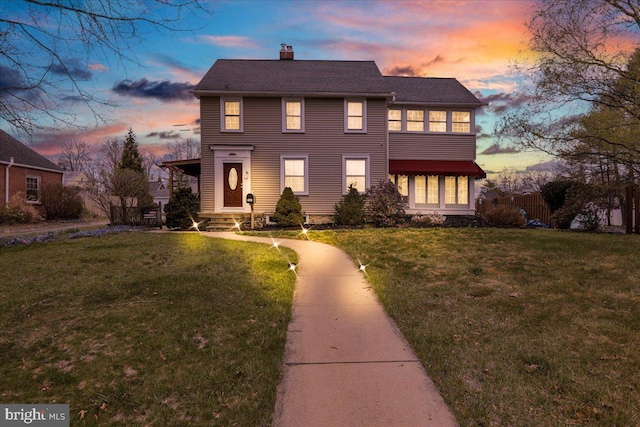 view of front of property featuring a front yard and a chimney
