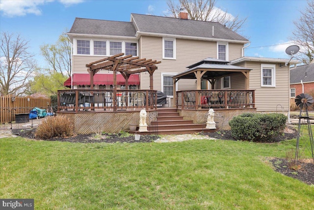 back of property with a yard, a chimney, fence, and a pergola