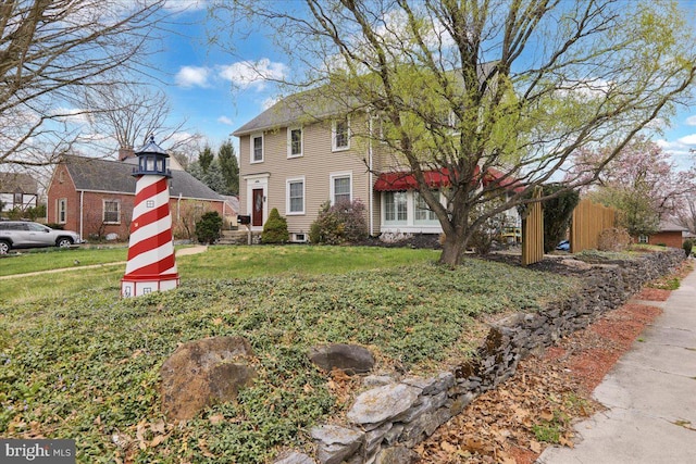 colonial home with a front lawn