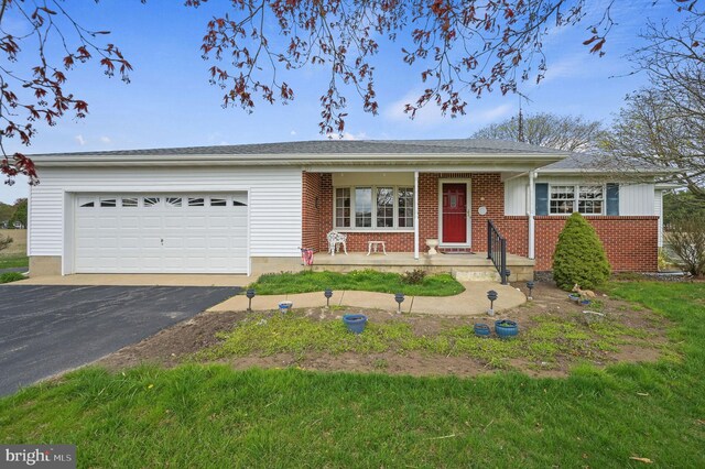 328 Moose Lodge Rd, Camden Wyoming, DE 19934 - ranch-style house featuring an attached garage, driveway, brick siding, and a porch
