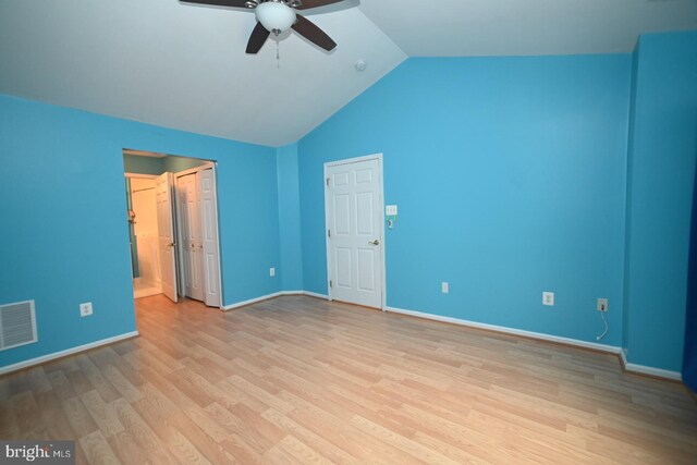 unfurnished bedroom with visible vents, baseboards, a ceiling fan, light wood-style flooring, and lofted ceiling