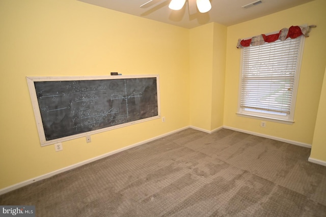 empty room with ceiling fan, baseboards, visible vents, and carpet floors