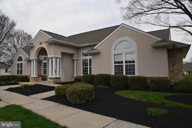 view of front of house with stucco siding and stone siding