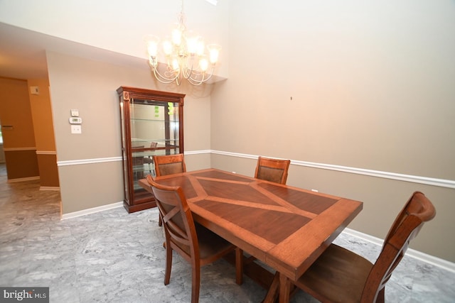 dining room with an inviting chandelier and baseboards
