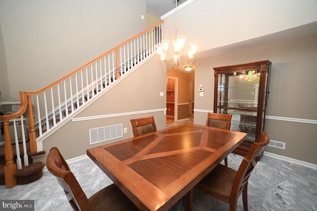 dining room featuring a notable chandelier, visible vents, and stairs