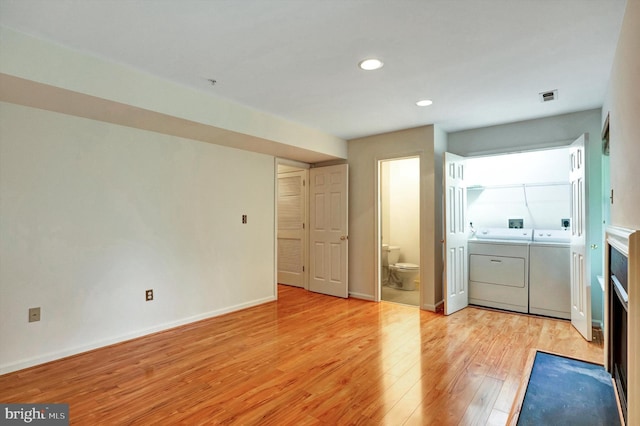 laundry area with washer and clothes dryer, laundry area, visible vents, recessed lighting, and light wood finished floors