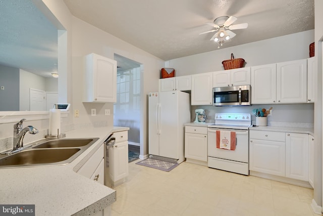 kitchen with a sink, white cabinetry, a ceiling fan, and white appliances