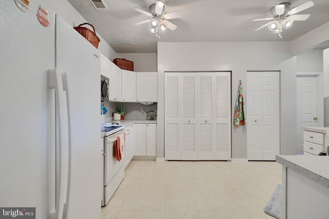 kitchen featuring a ceiling fan, white cabinetry, white appliances, and light countertops