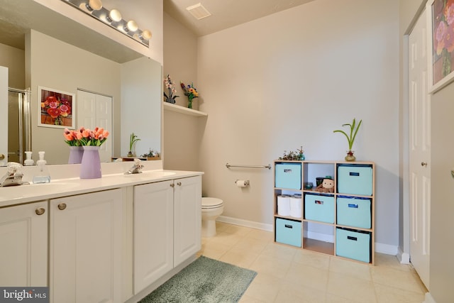 bathroom with visible vents, a sink, baseboards, and double vanity