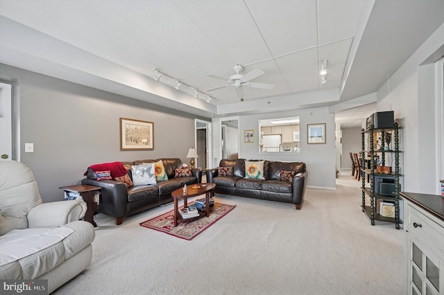 living room with rail lighting, ceiling fan, and light carpet